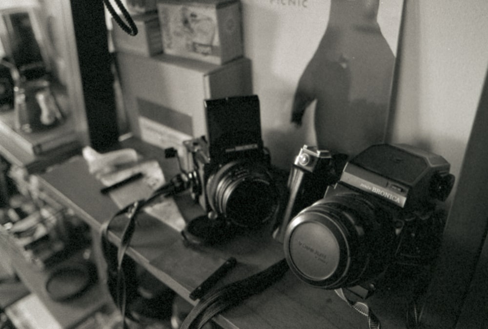 a black and white photo of two cameras