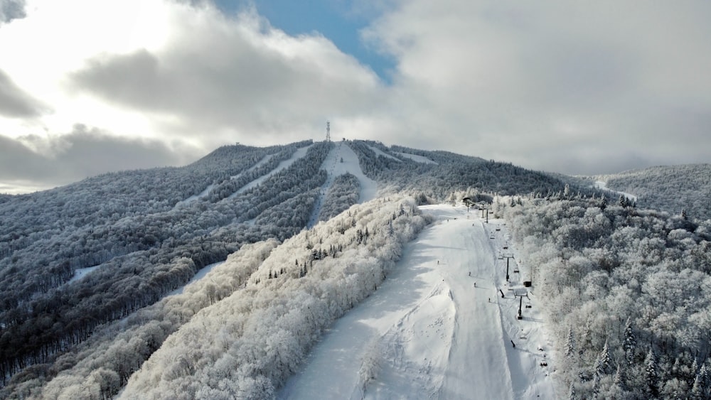 a snow covered mountain with a ski lift on top of it