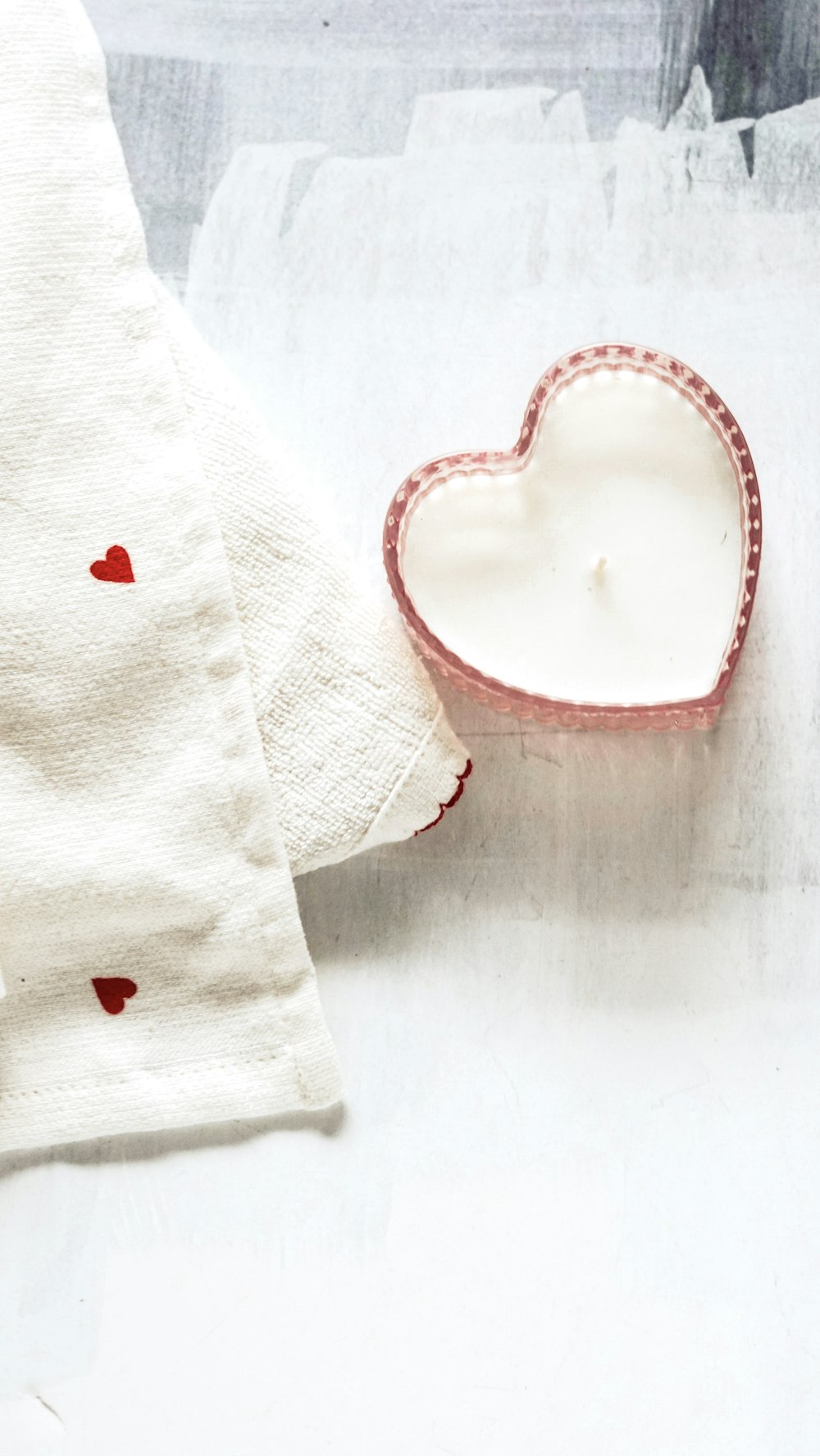 a heart shaped dish sitting on top of a table