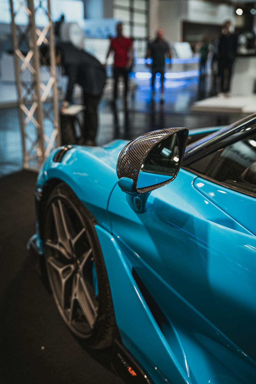 a blue sports car parked in a showroom