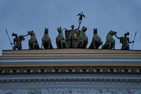 a group of statues on top of a building