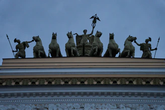 a group of statues on top of a building