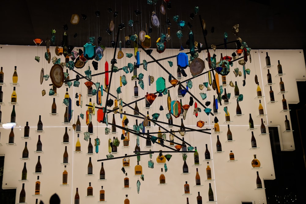a display of glass bottles and spoons on a wall
