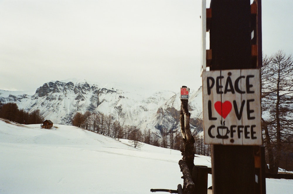 a sign that says peace love coffee on a pole