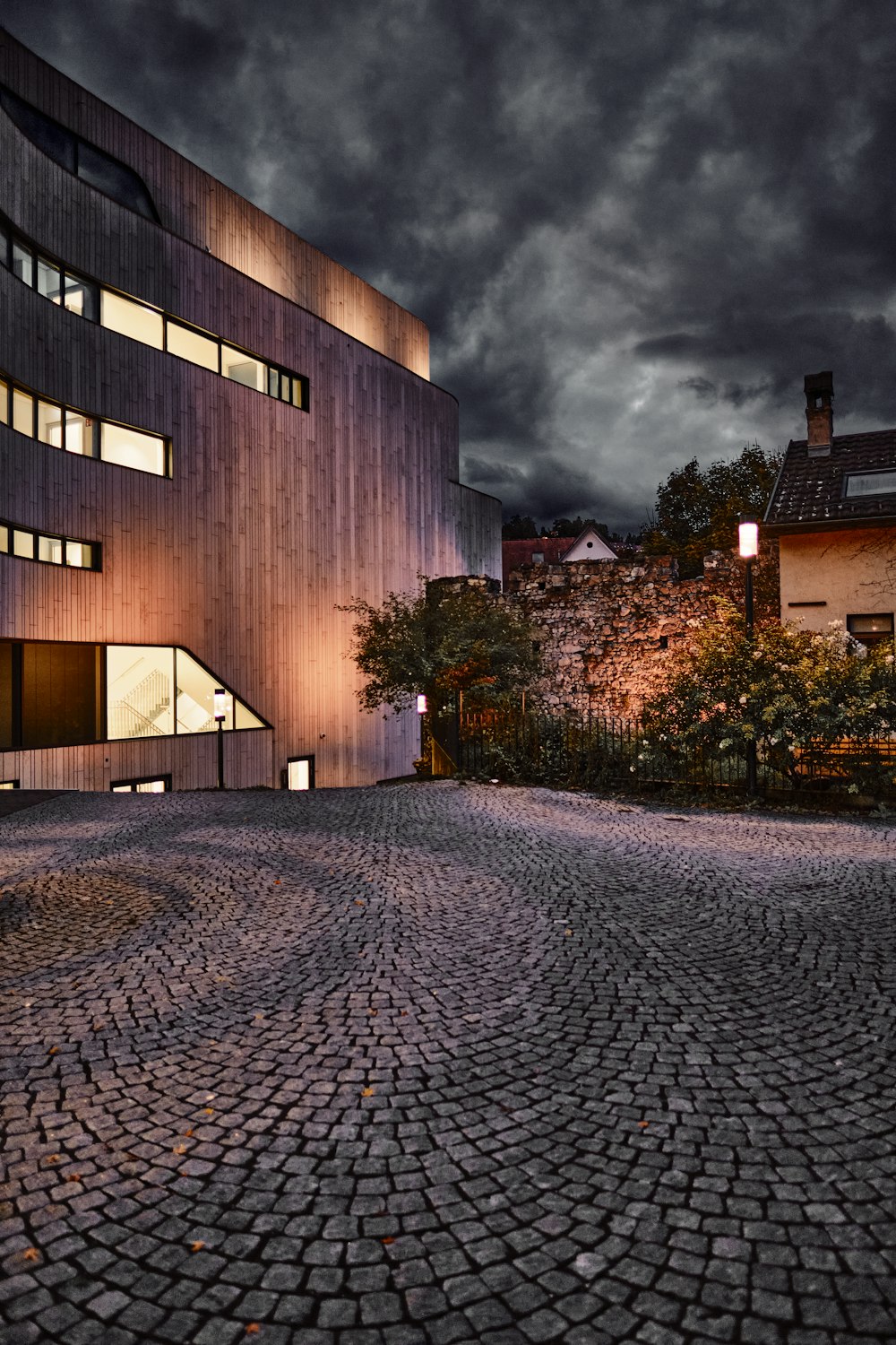 a cobblestone street with a building in the background