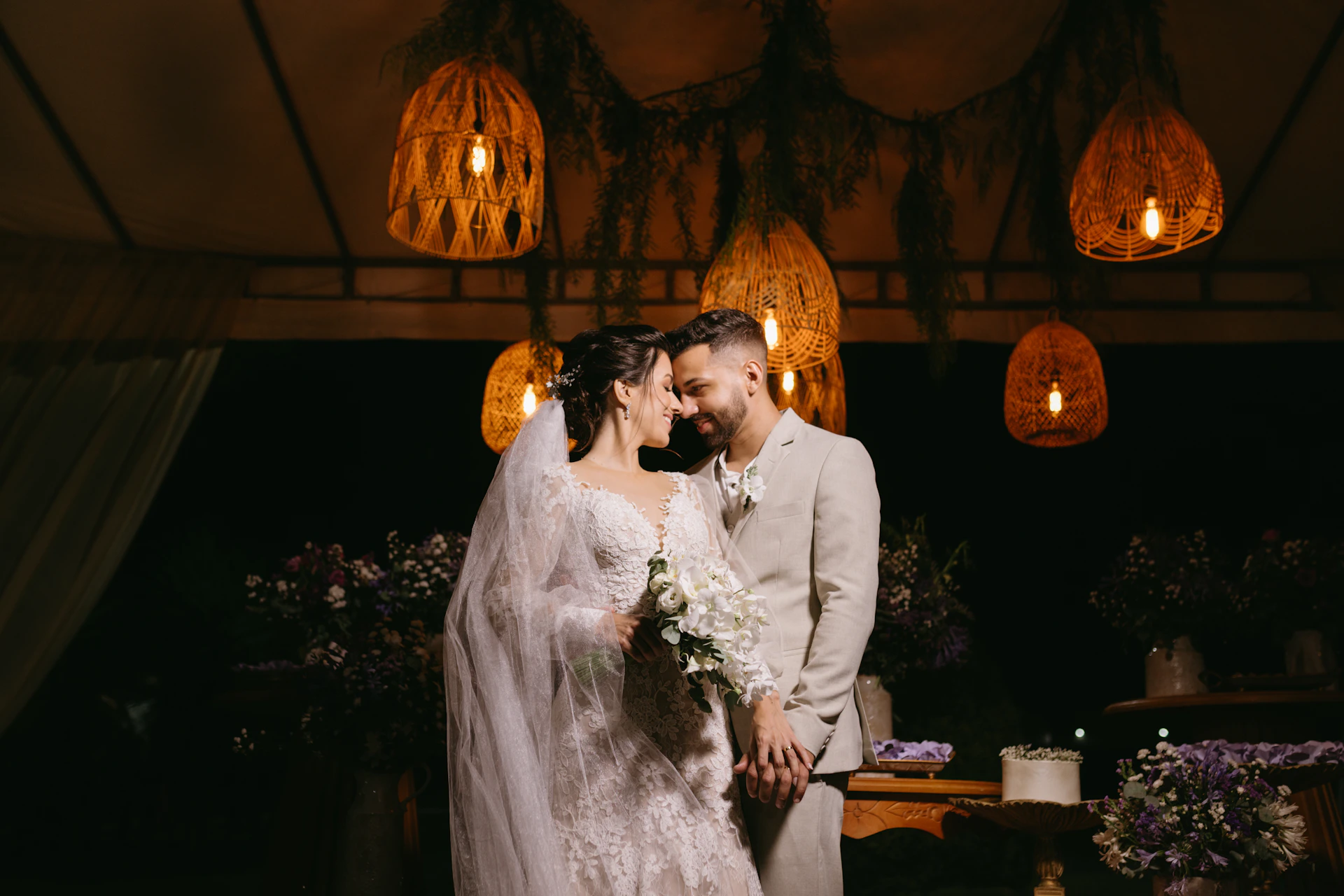 a bride and groom standing in front of a cake