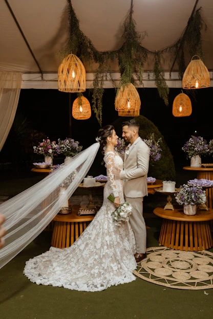 a bride and groom standing under a canopy