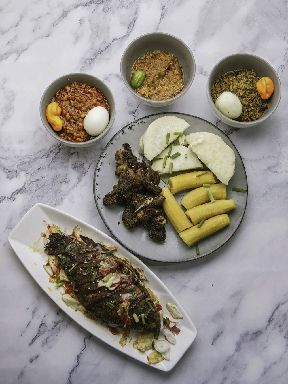 a table topped with plates of food and bowls of food