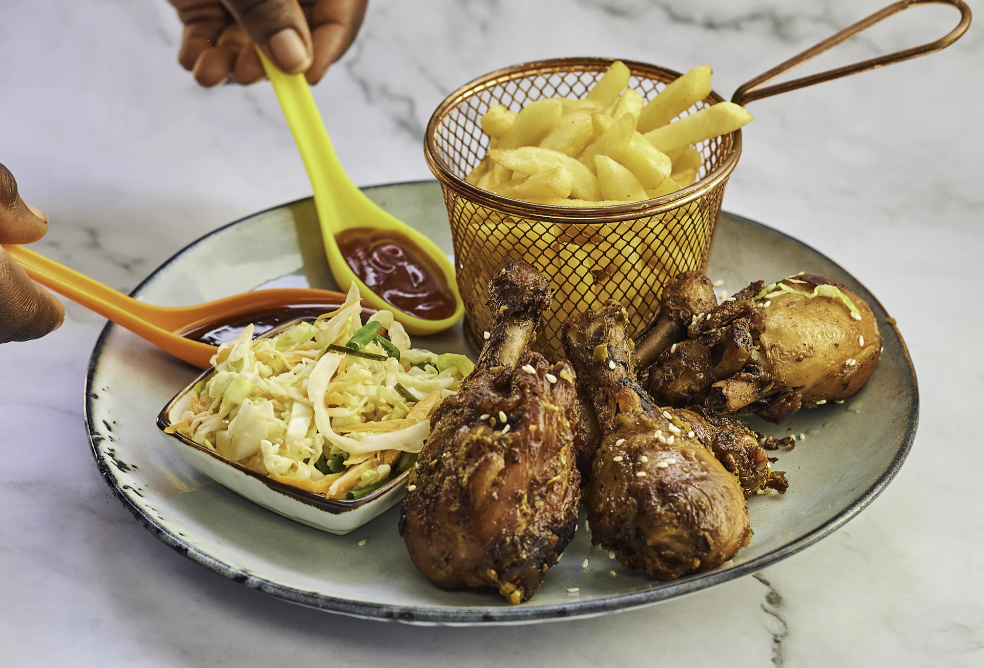 a plate of food that includes chicken, potatoes, and coleslaw