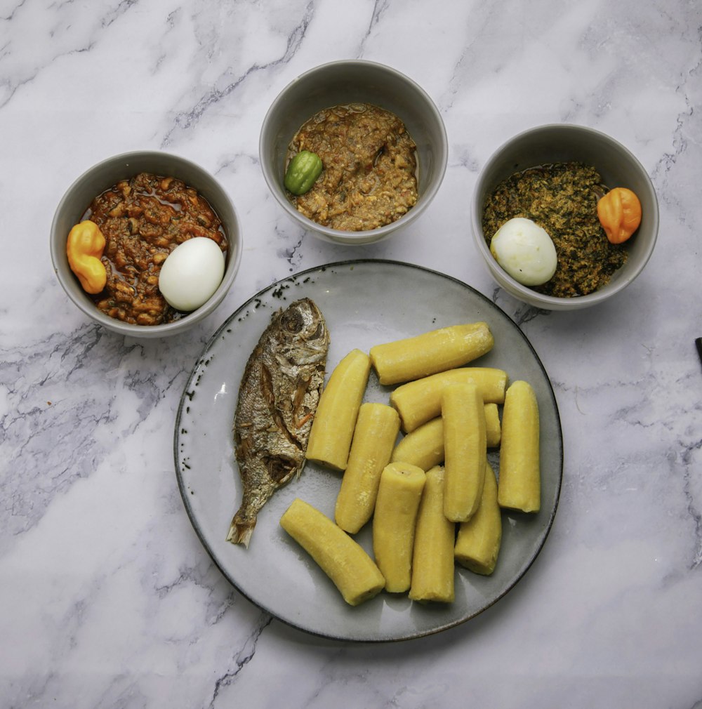 three bowls of food on a marble table