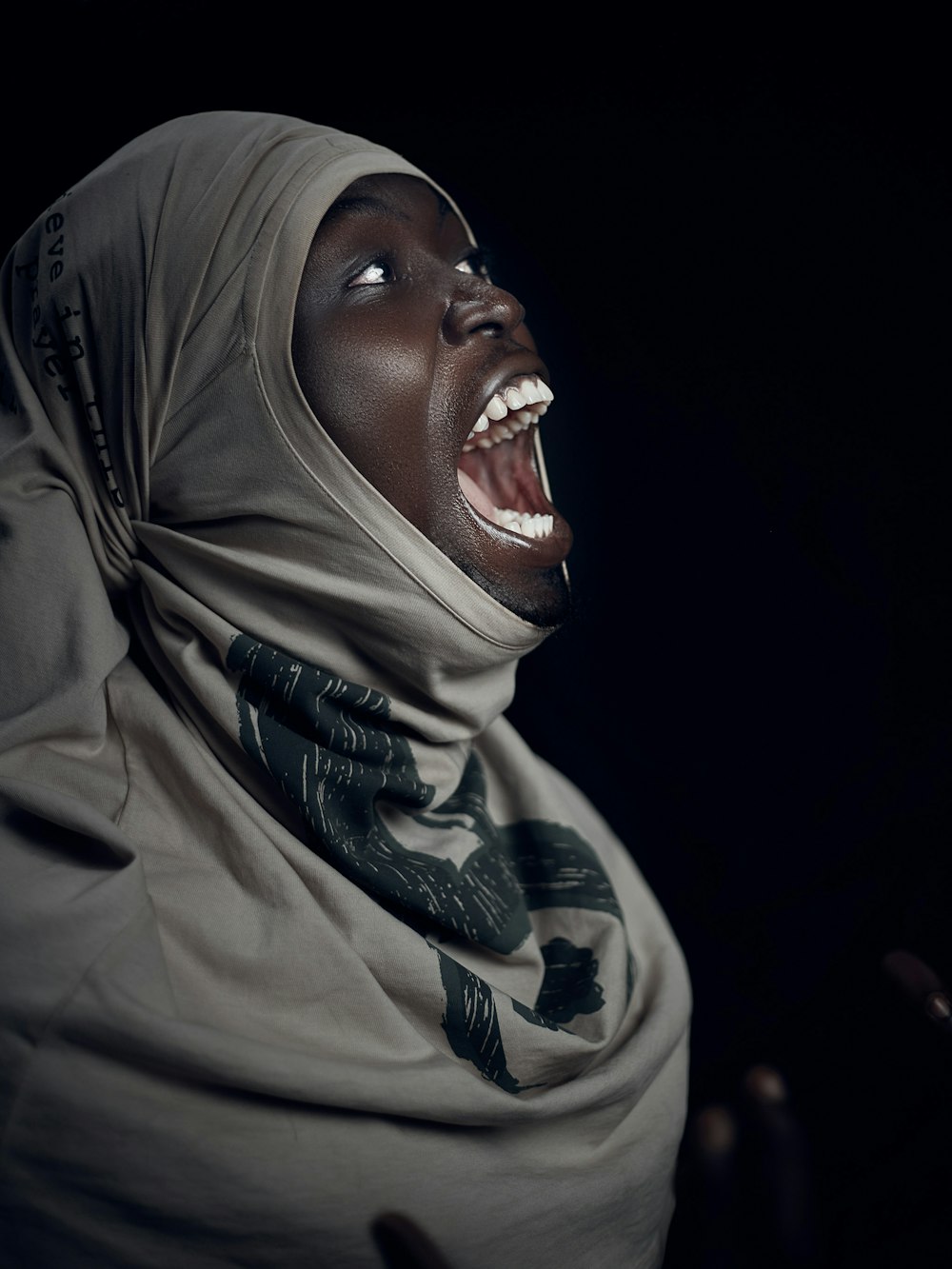 a woman in a headscarf with her mouth open