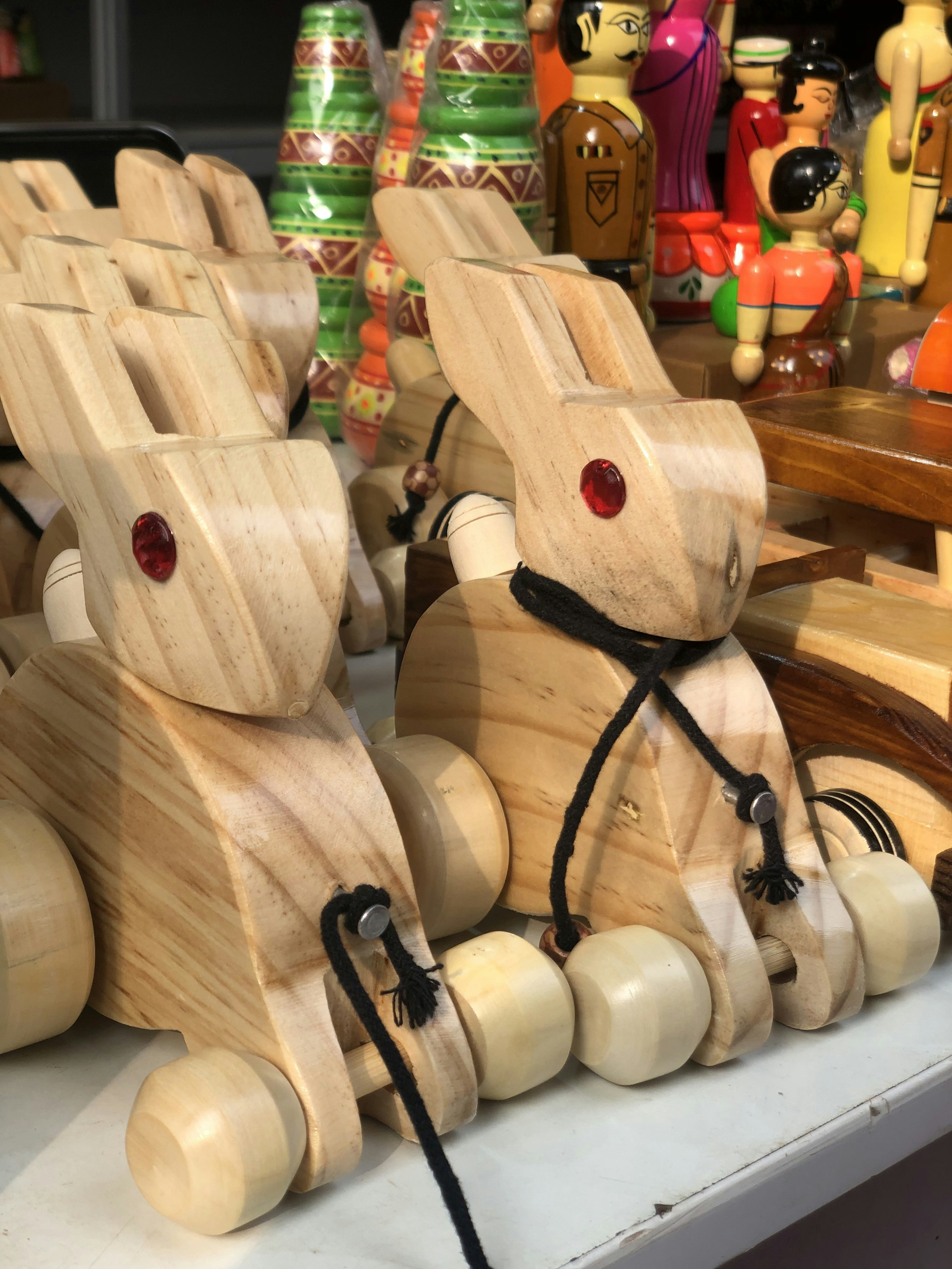 a couple of wooden rabbits sitting on top of a table