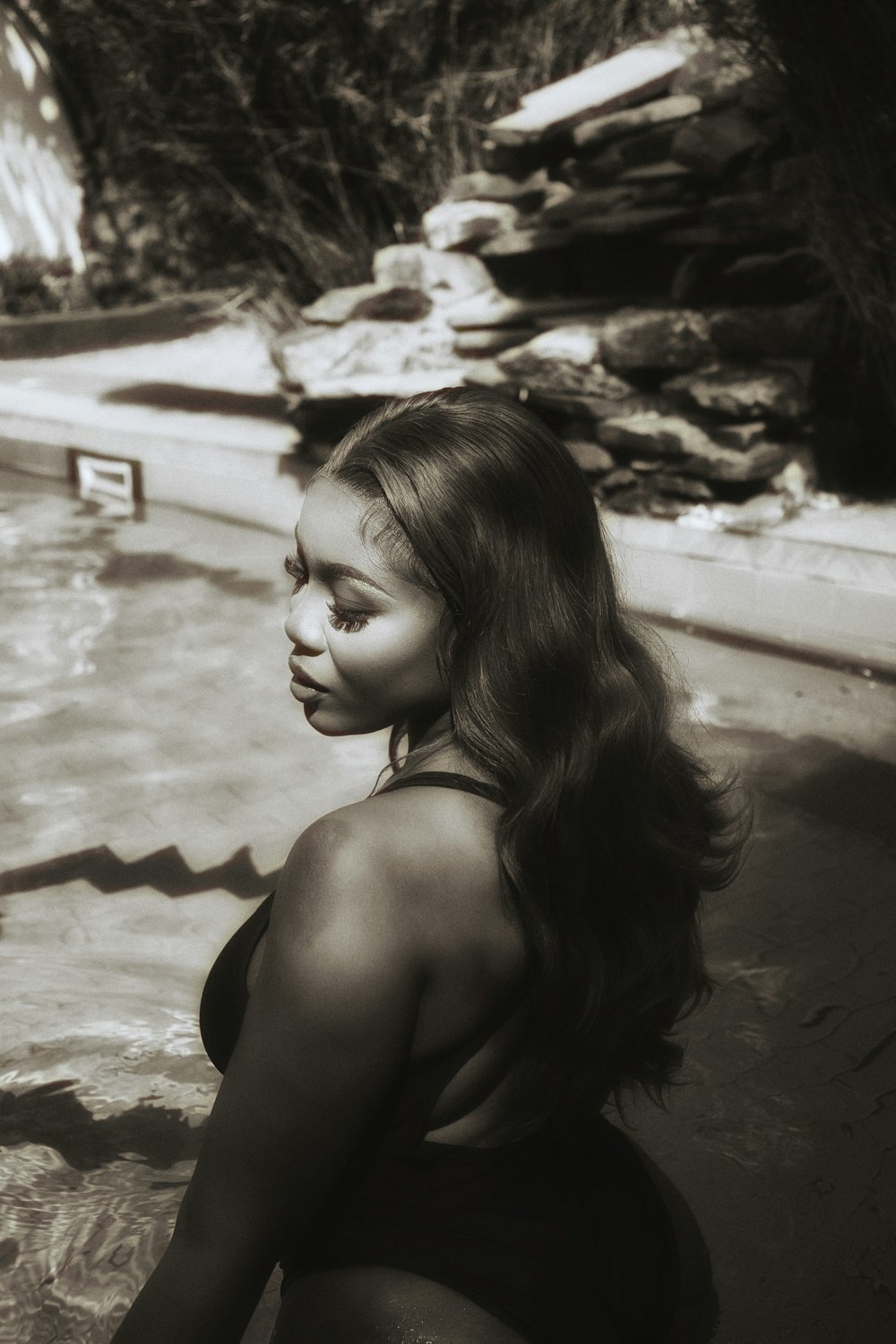 a black and white photo of a woman in a bathing suit