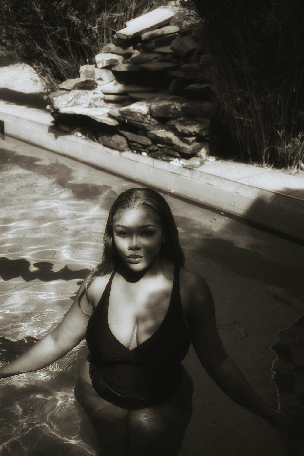 a woman in a bathing suit standing in a pool
