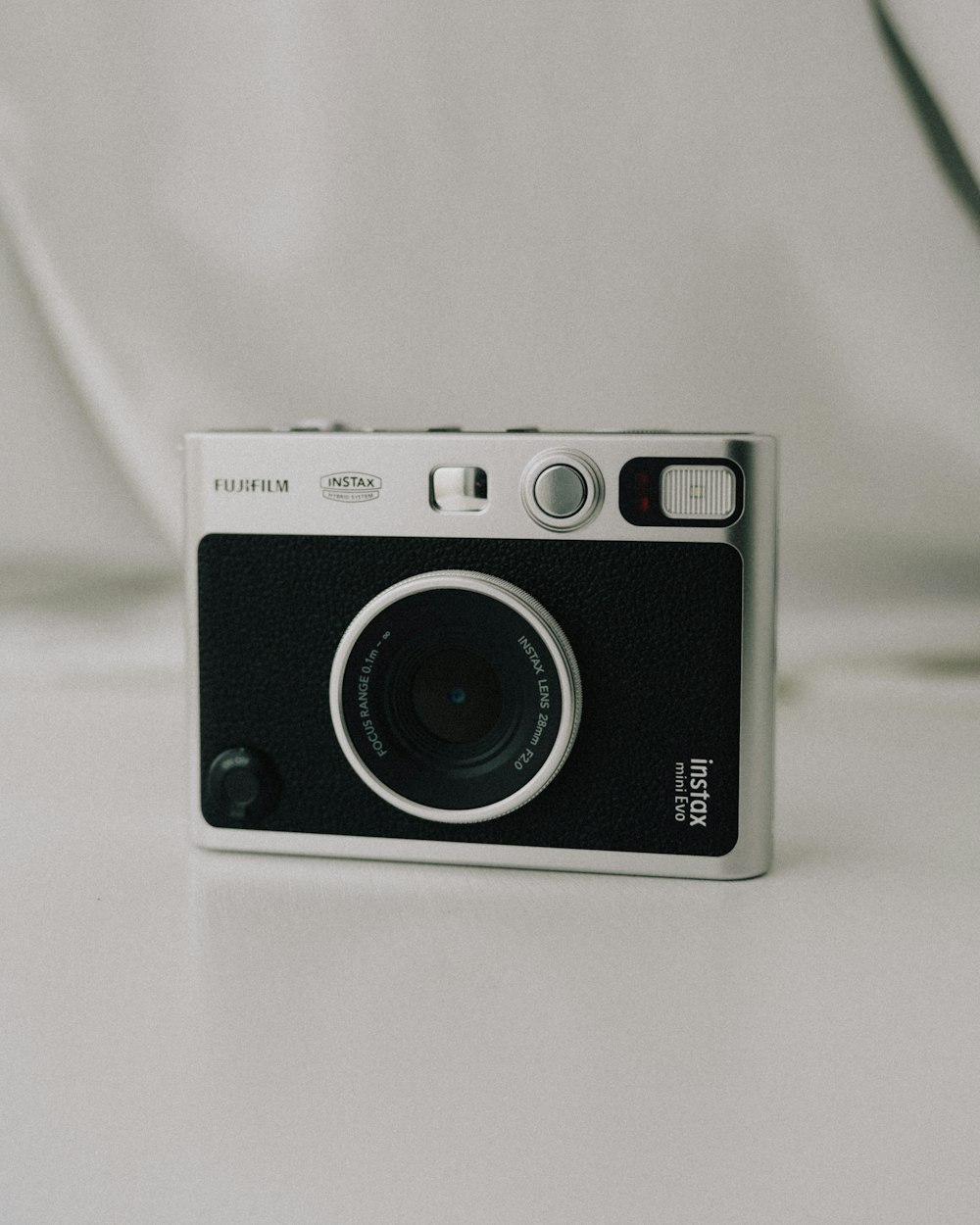 a white and black camera sitting on top of a table