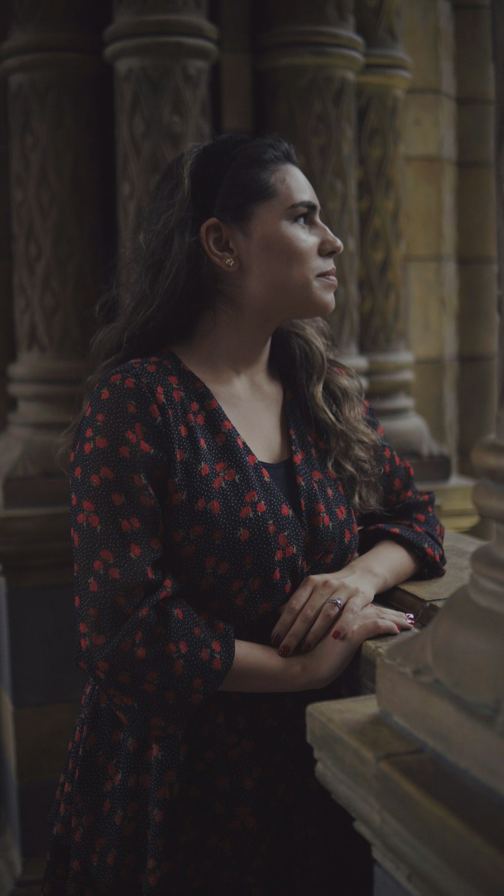 a woman standing in front of a pillar