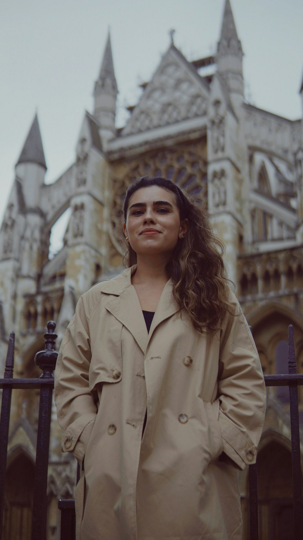 a woman standing in front of a castle