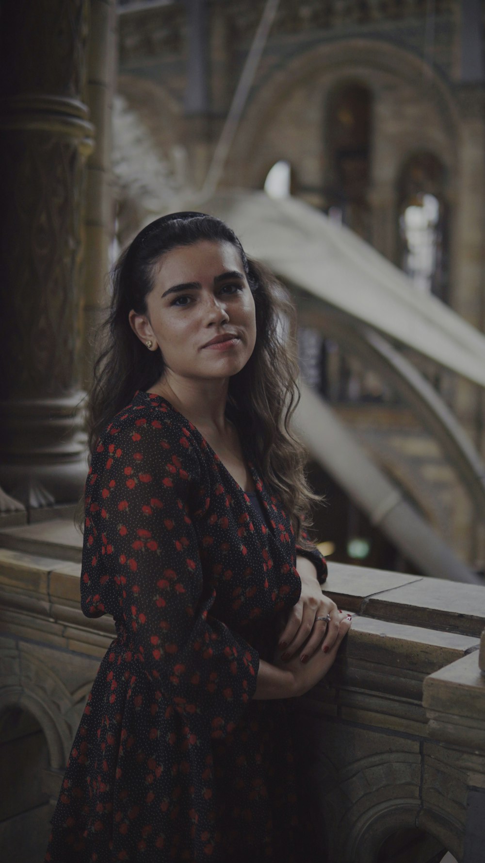 a woman leaning against a wall in a building