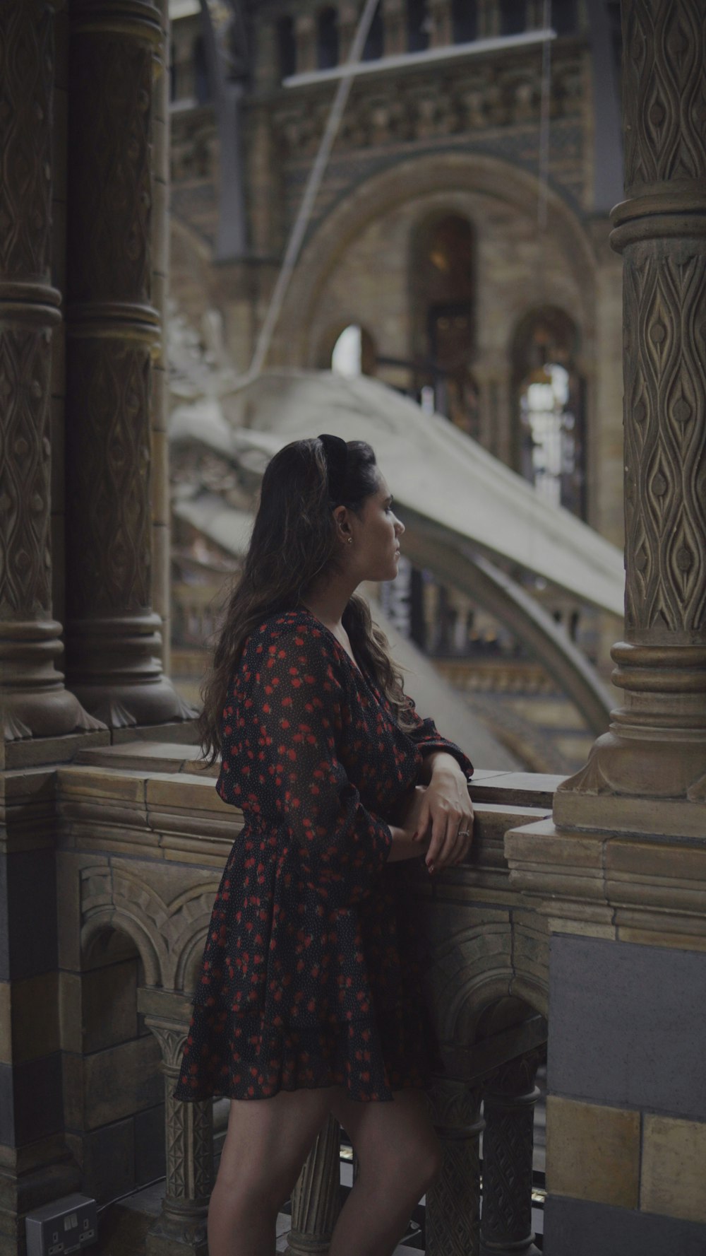 a woman leaning against a wall in a building