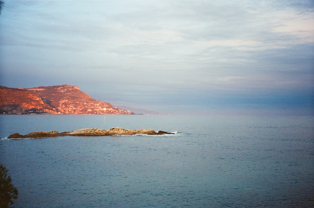 a body of water with a small island in the middle of it