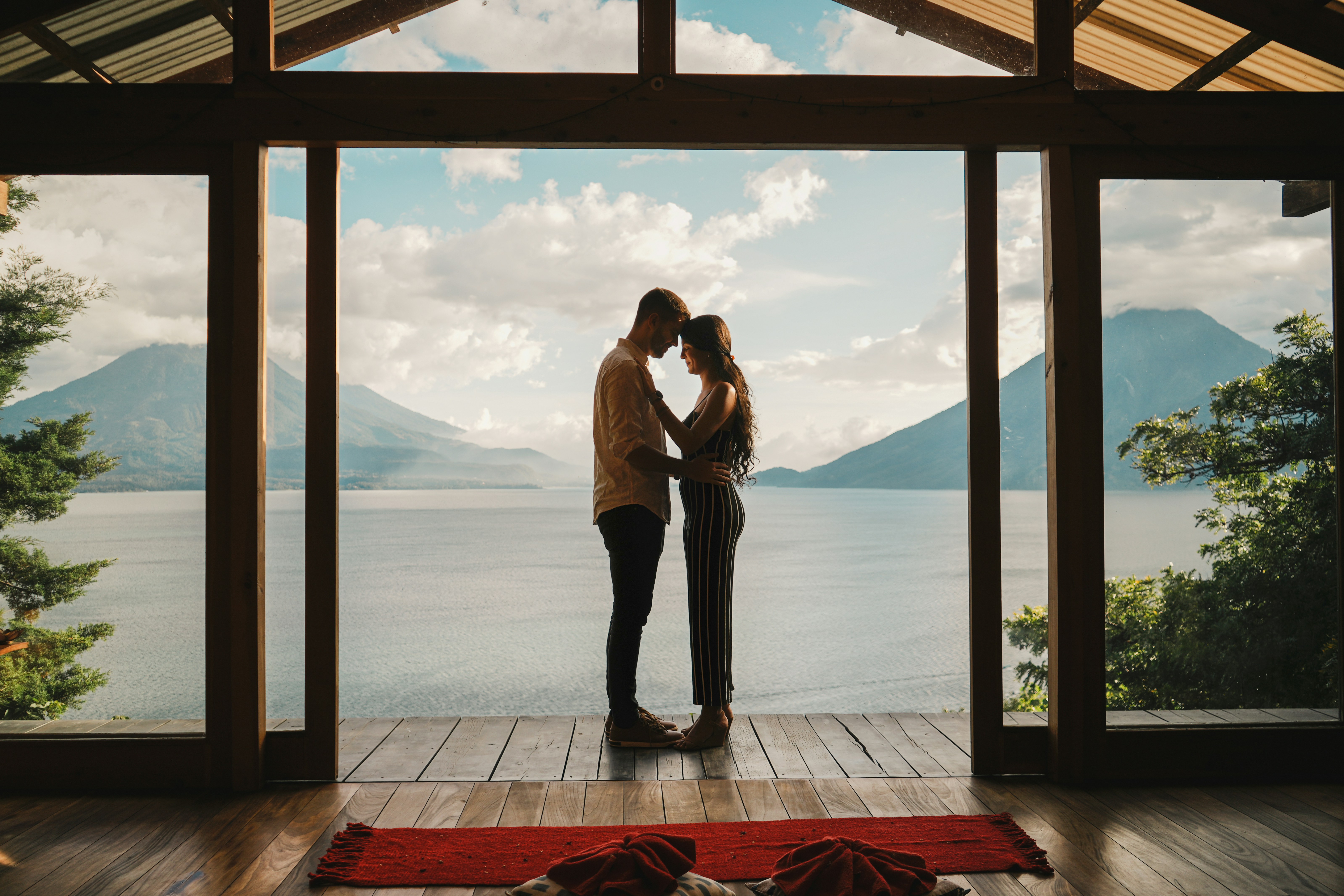 A man and a woman standing in front of a window photo – Free Grey Image ...