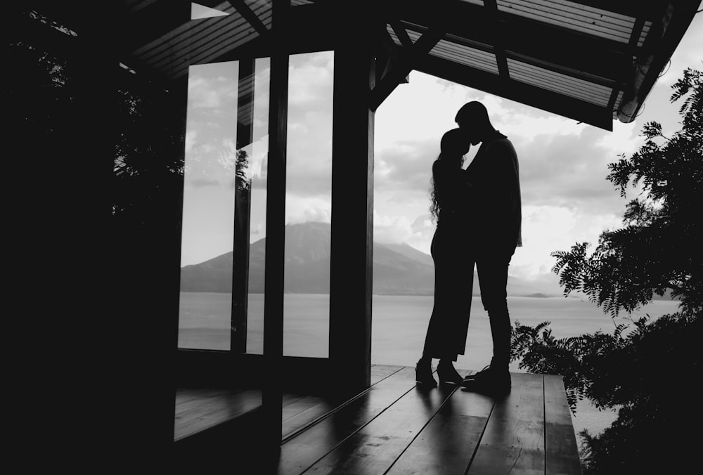 a couple of people standing on a wooden platform