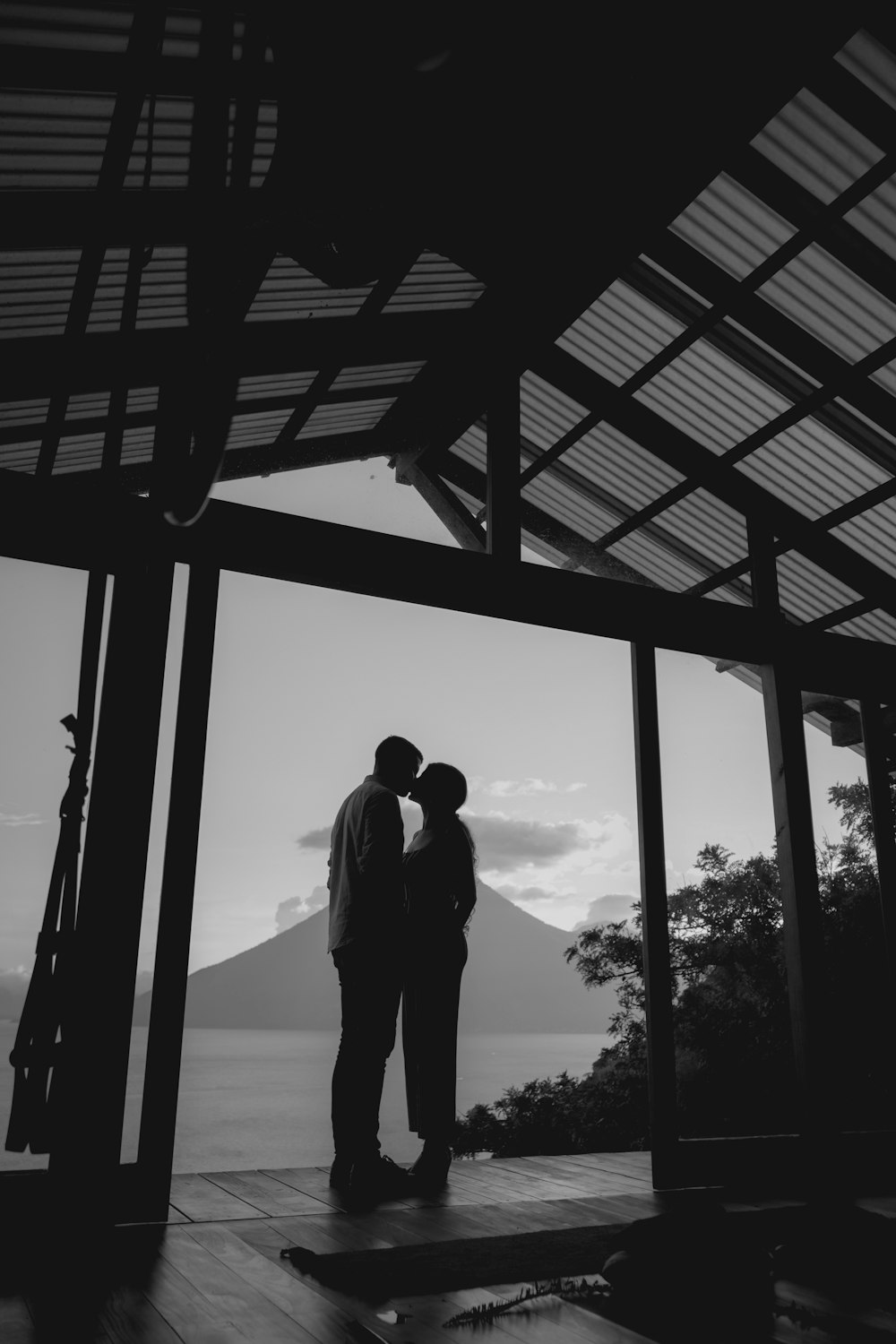 a man and a woman standing in front of a gazebo