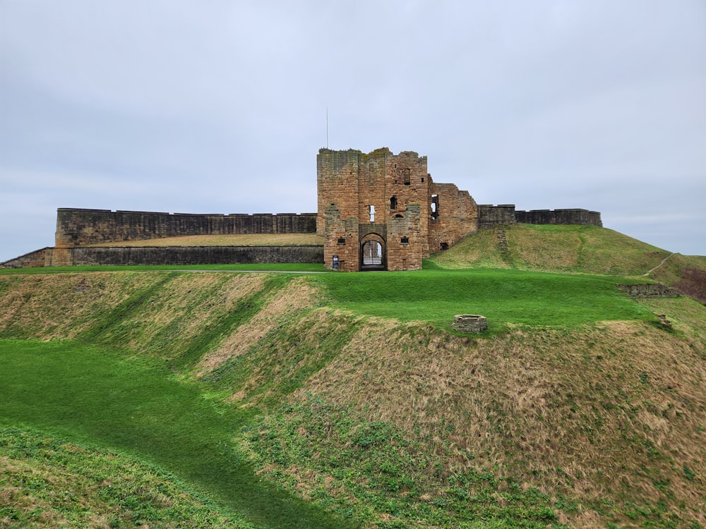 a castle on top of a grassy hill