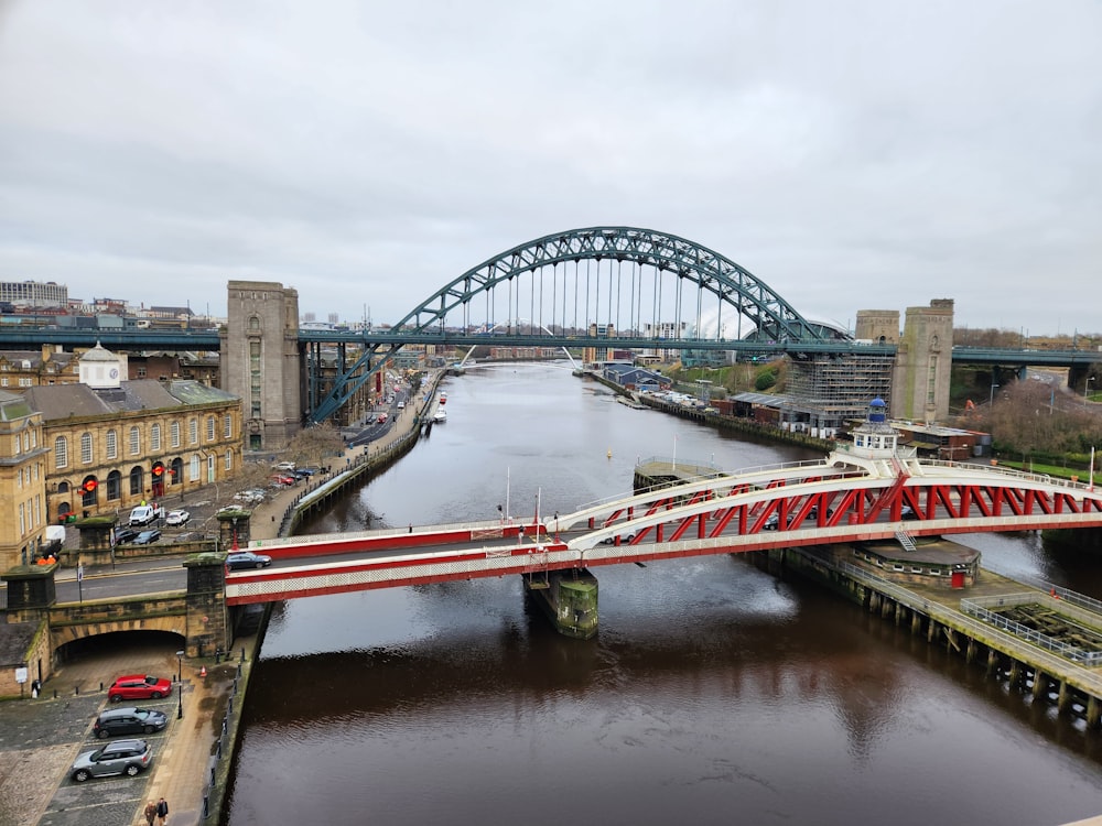 a bridge over a river next to a tall building