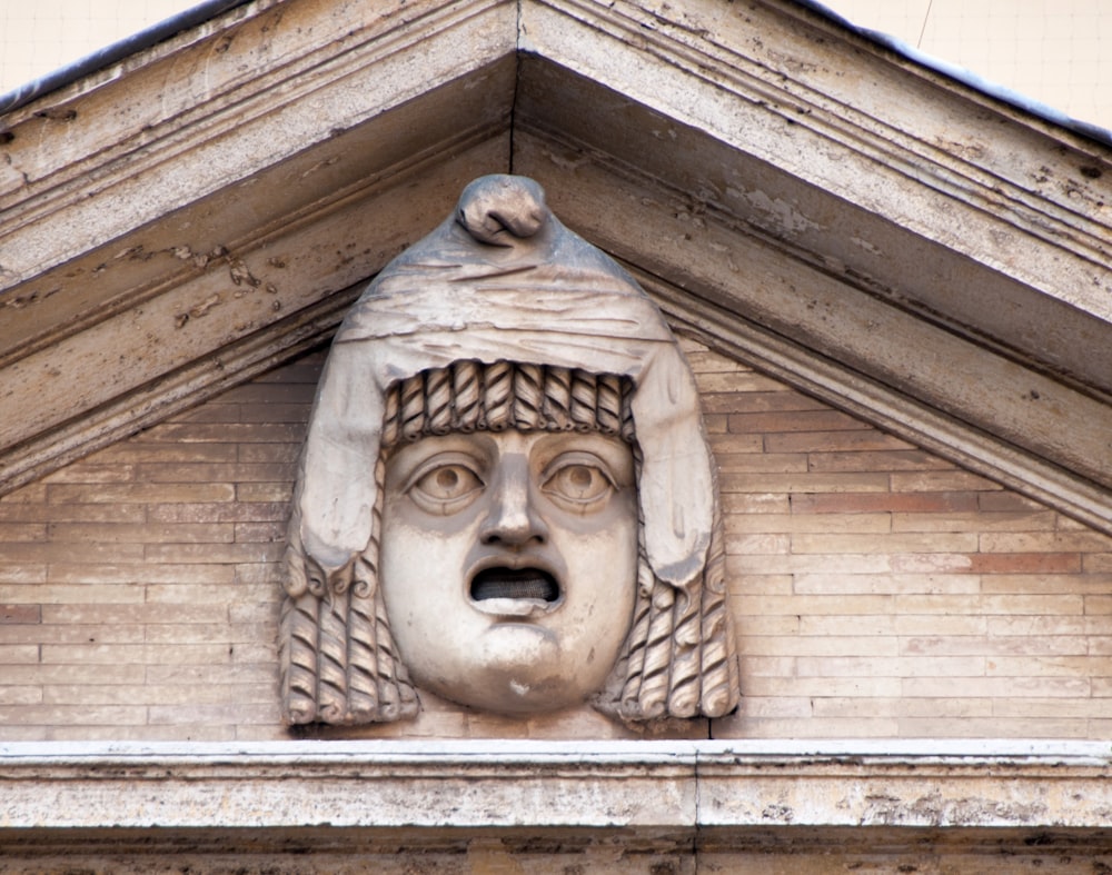 a close up of a face on a building