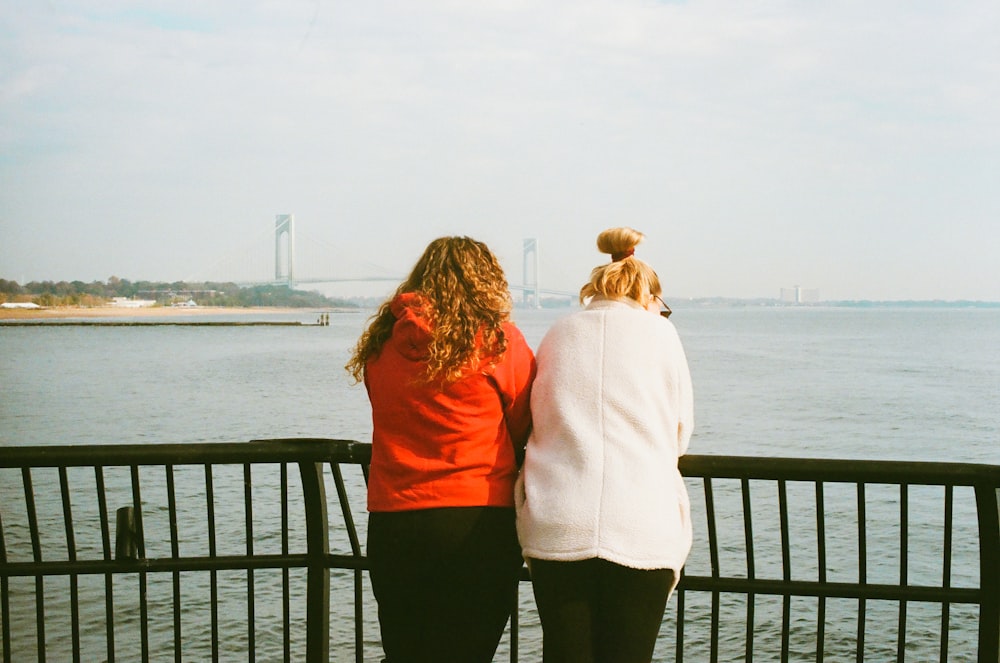 two women looking out over a body of water