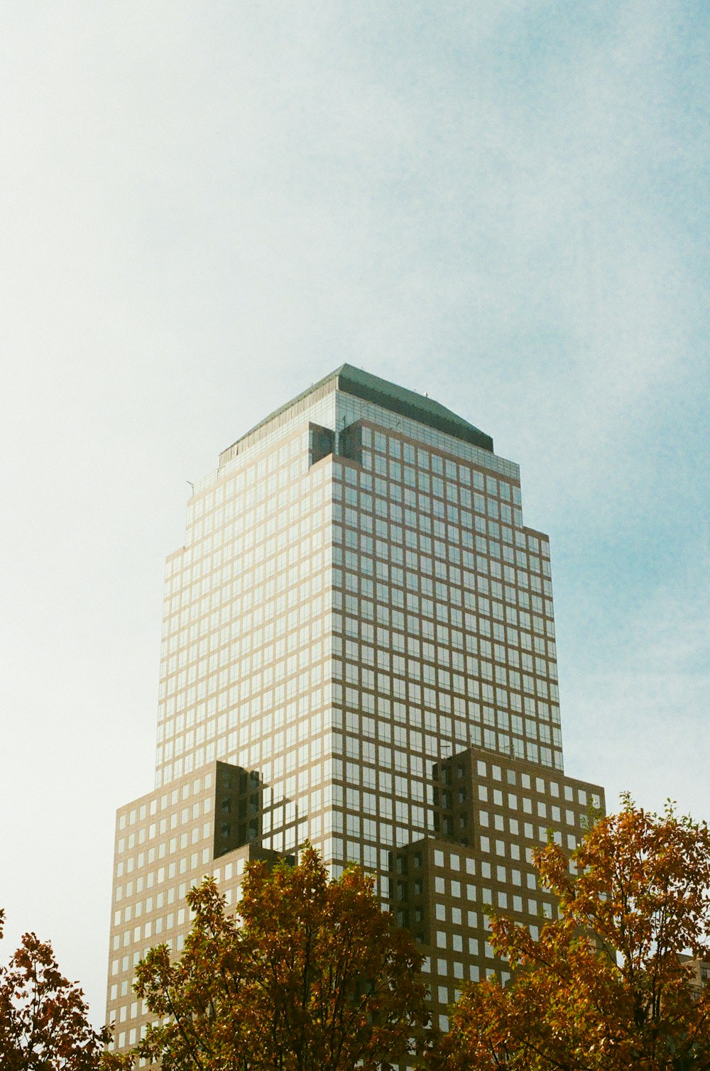 a very tall building with some trees in front of it