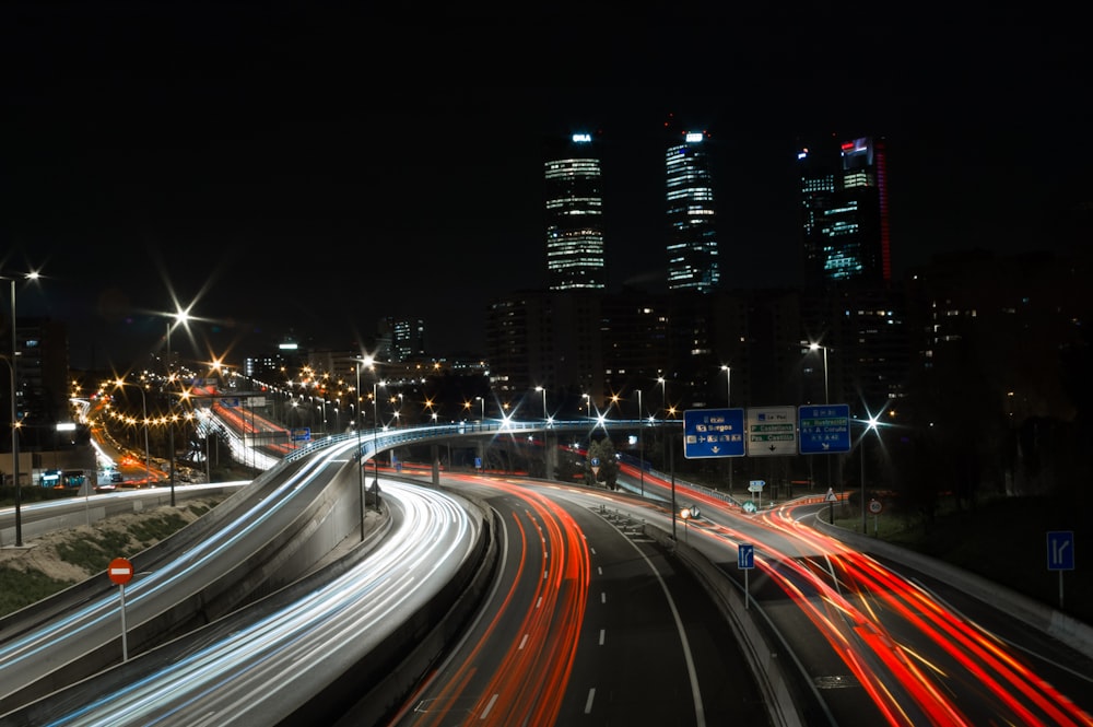 a city street filled with lots of traffic at night