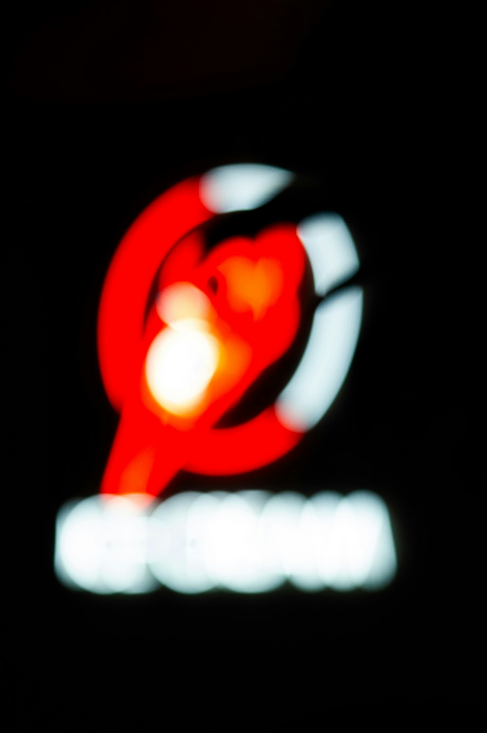 a close up of a red light in the dark
