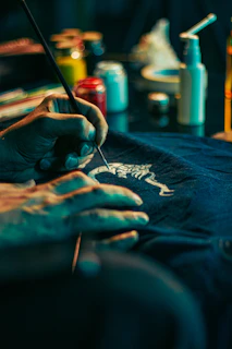 a person with their hands on a t - shirt