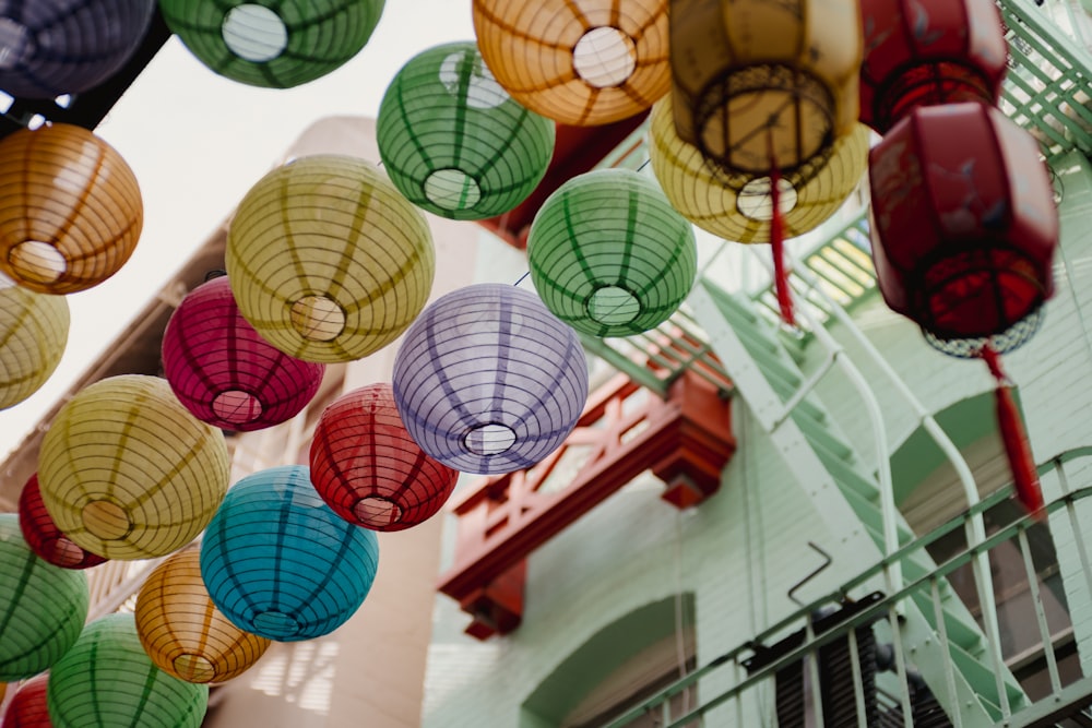 a group of colorful lanterns hanging from a ceiling