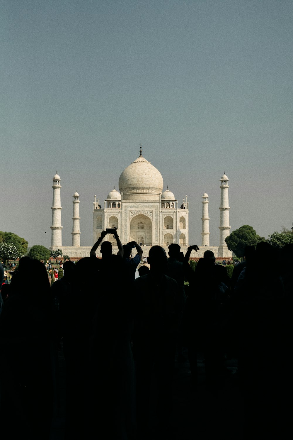 a group of people standing in front of a white building