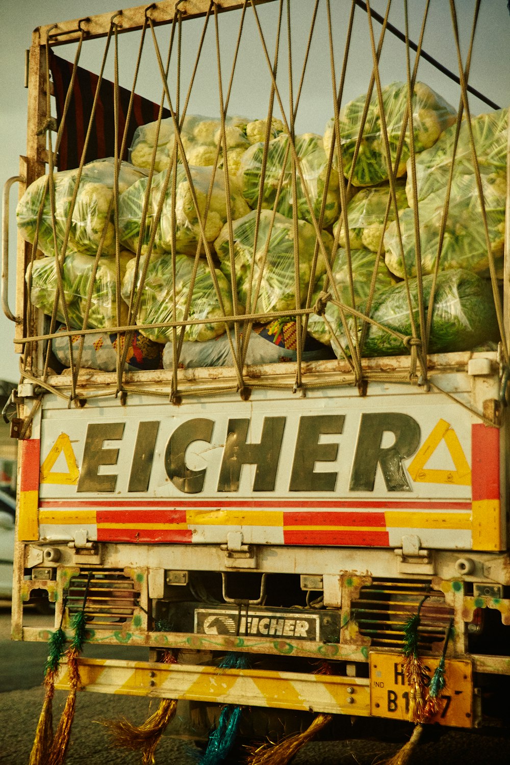 a truck filled with lots of green vegetables