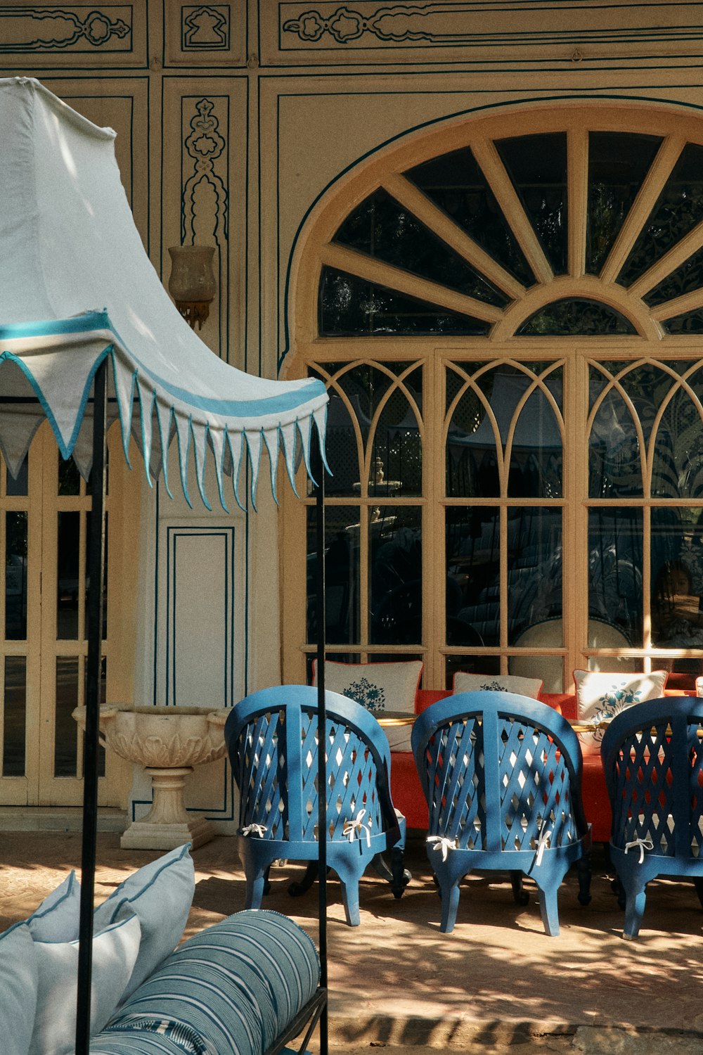 a group of blue chairs sitting in front of a building