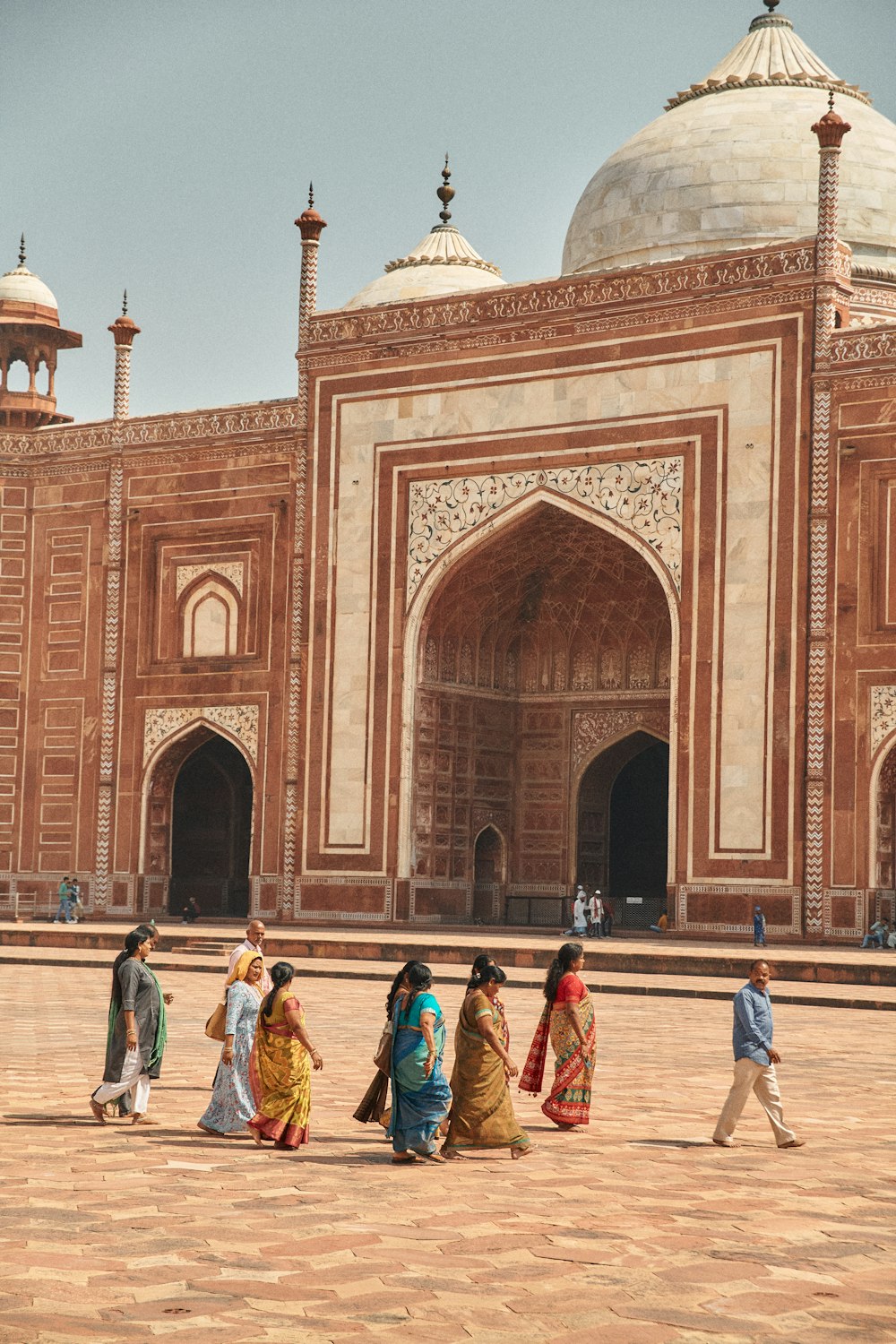 a group of people walking in front of a building