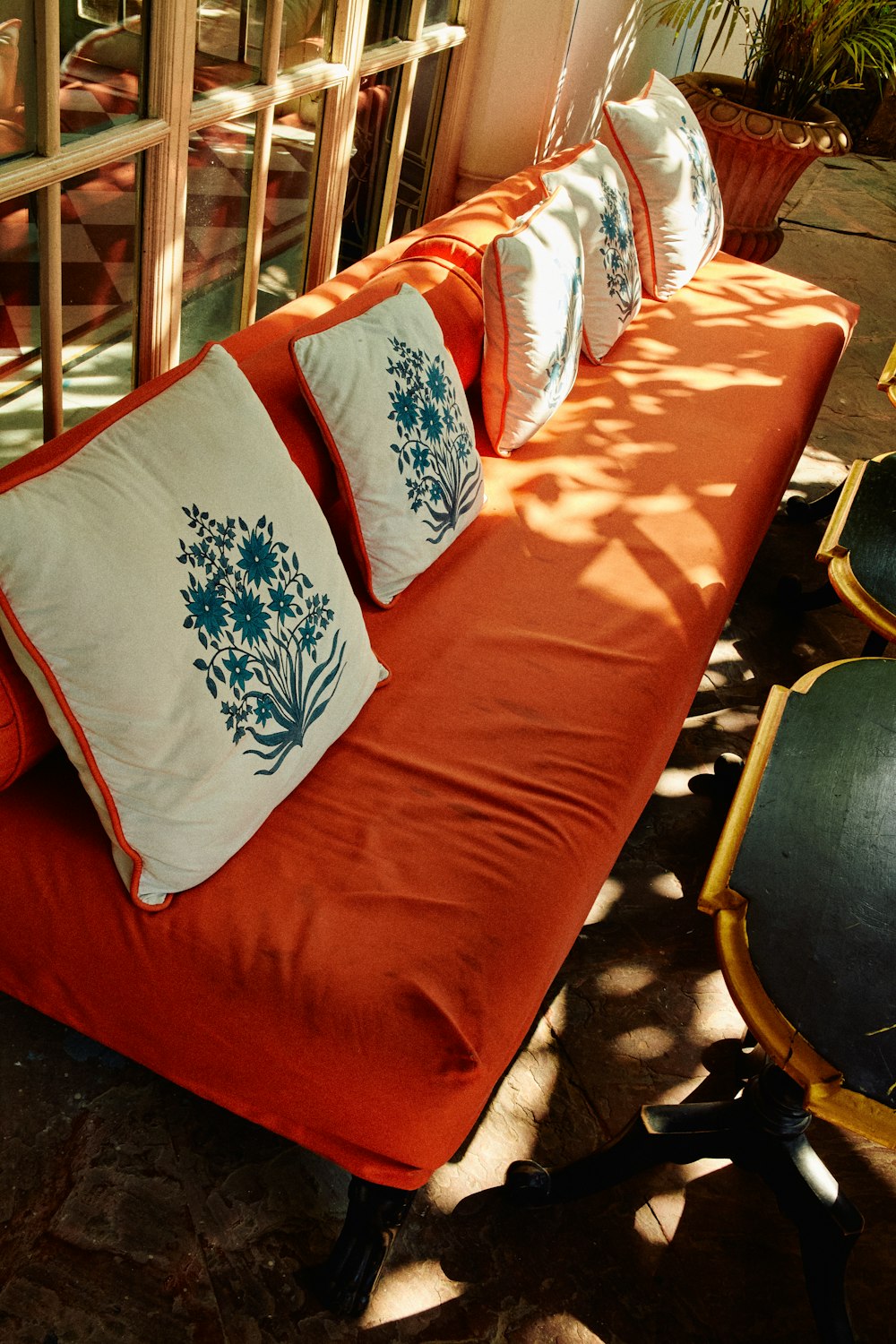 a red couch with four pillows on top of it