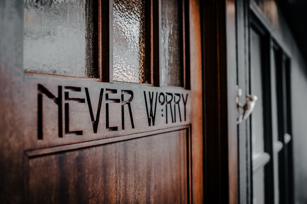 a wooden door with the words never worry written on it