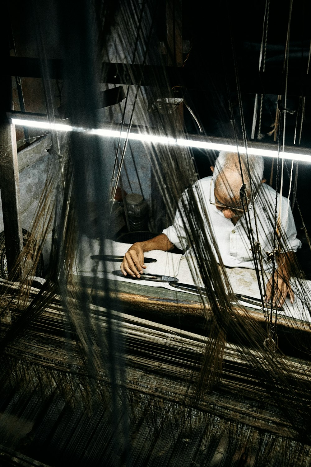 a man is working on a piece of wood