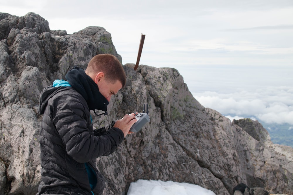 a man standing on top of a snow covered mountain