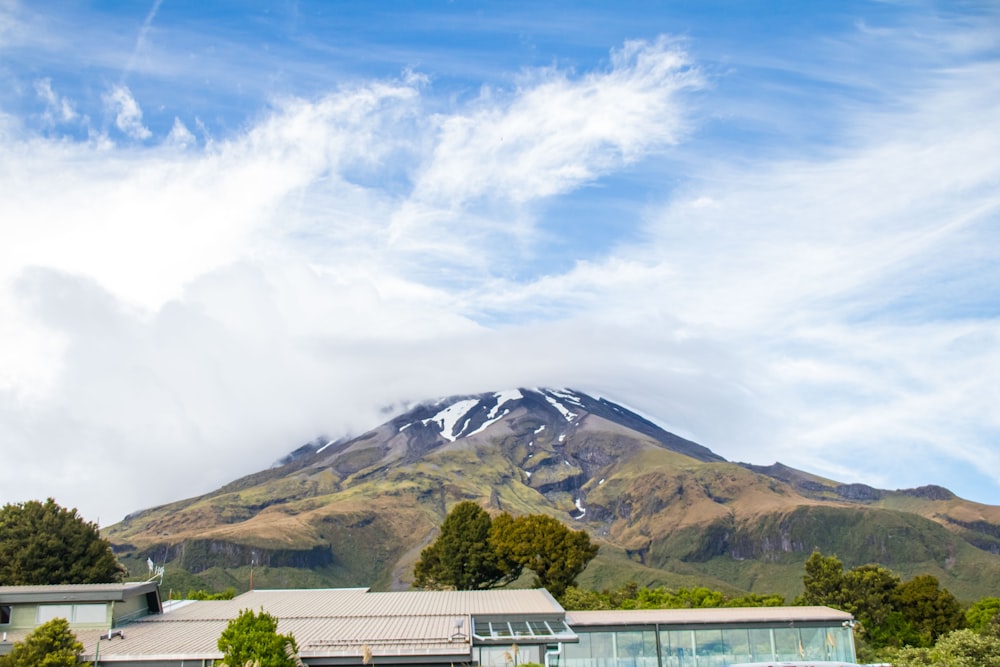 a view of a mountain with a house in the foreground