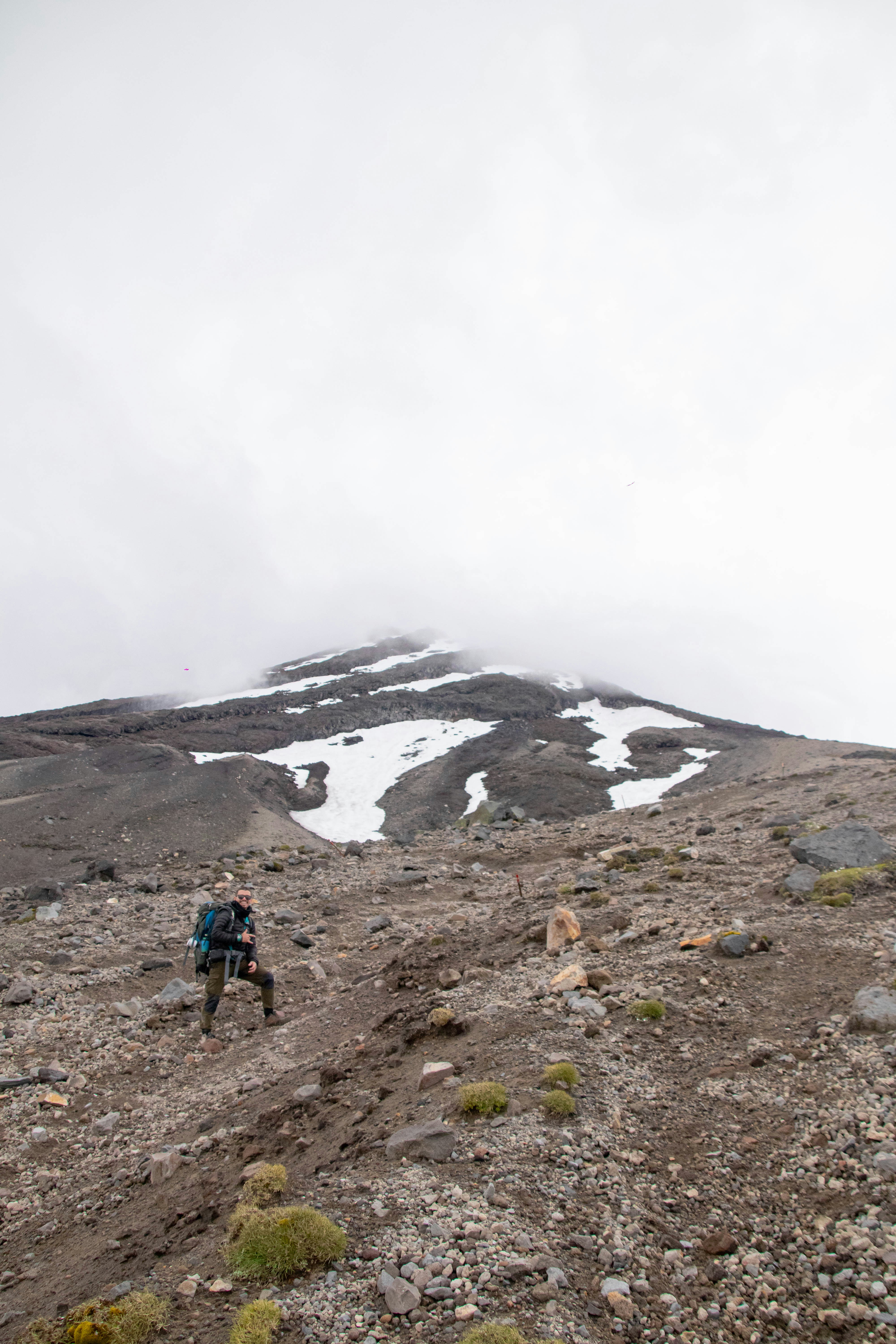 a man hiking up a mountain with a backpack
