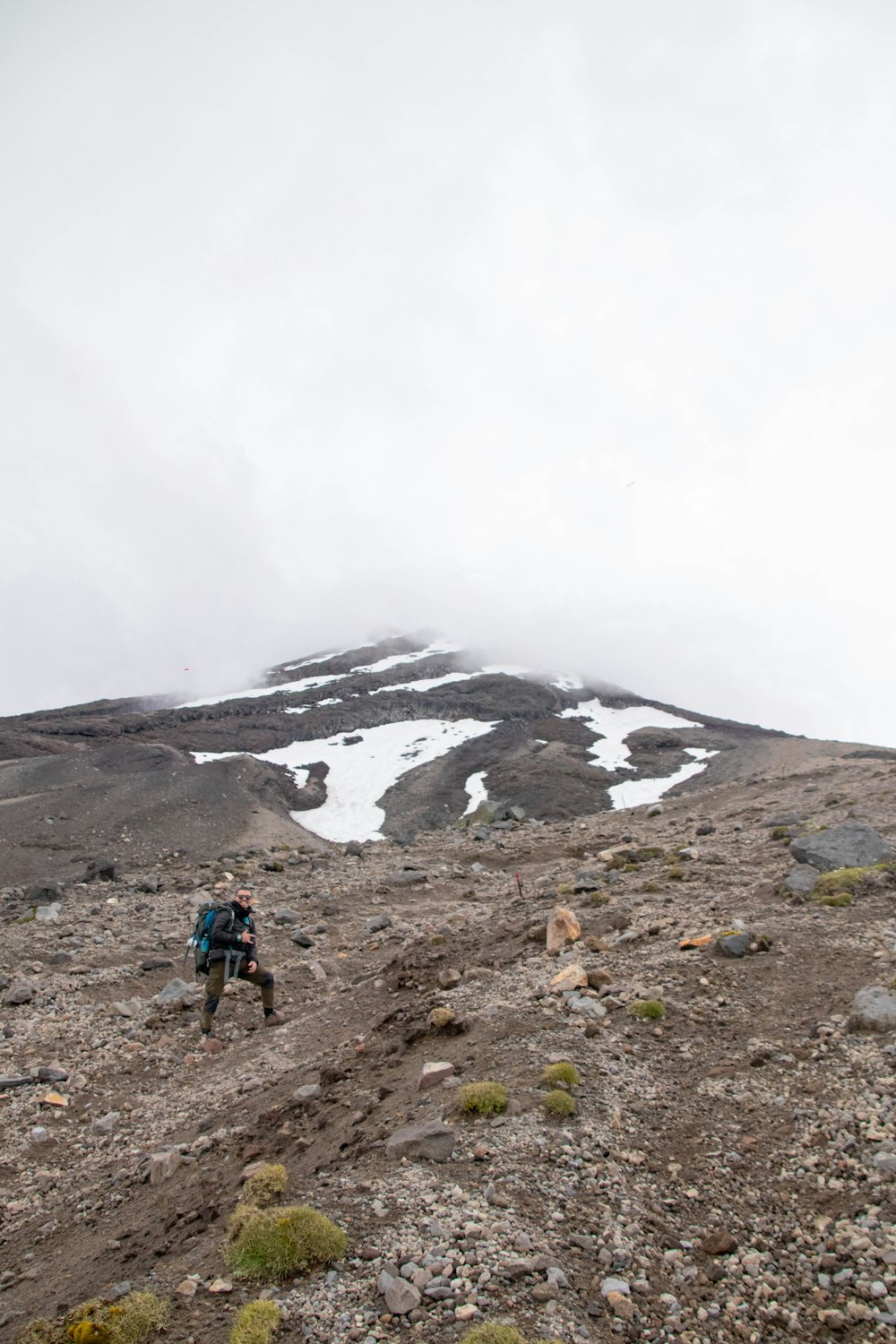 a man hiking up a mountain with a backpack