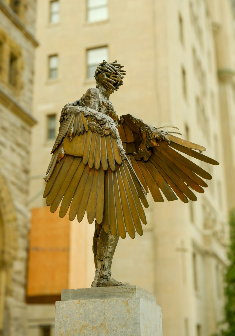 a statue of a woman with a large bird on her arm