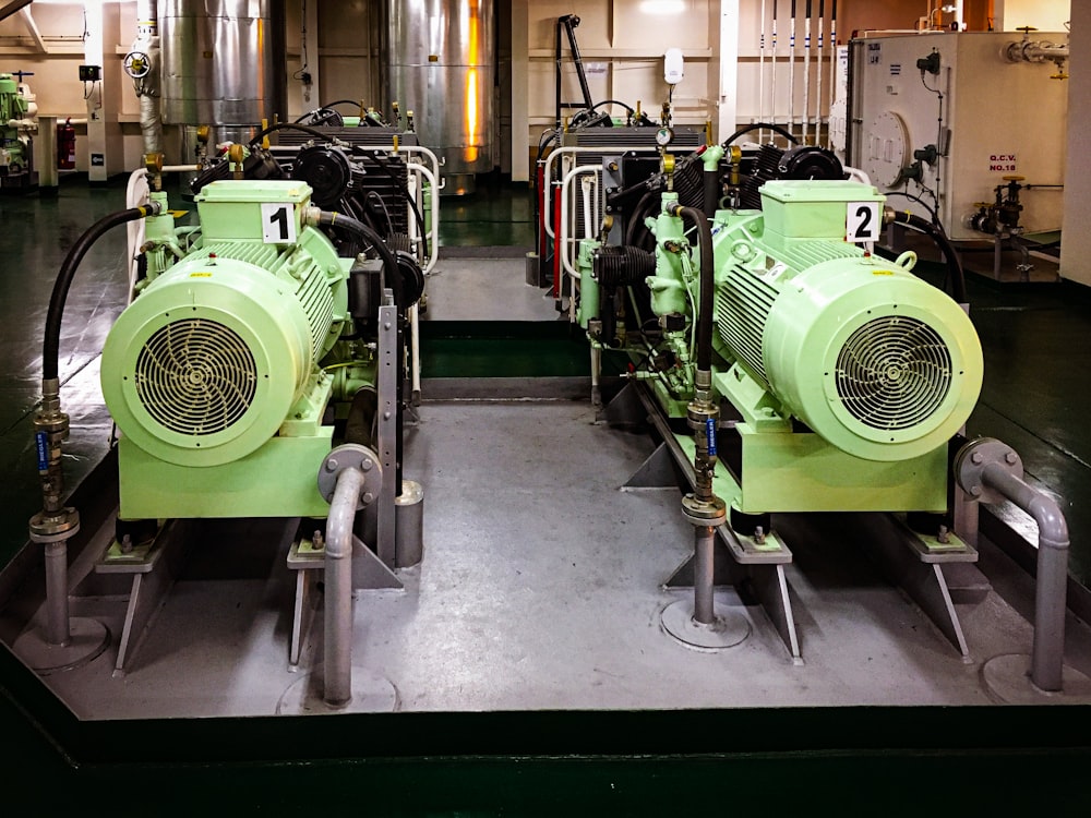 a couple of green machines sitting inside of a building