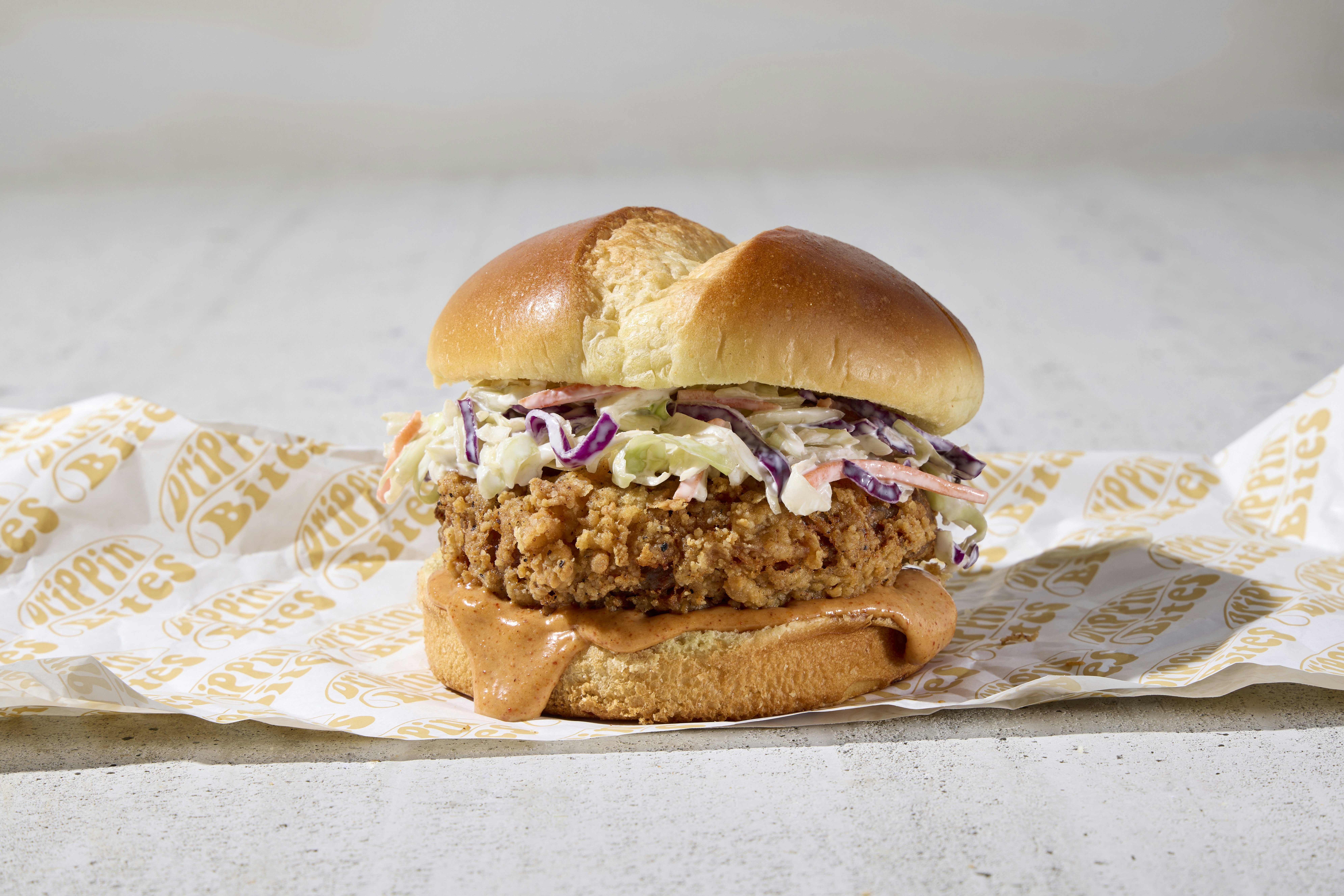 a fried chicken sandwich on a bun with coleslaw